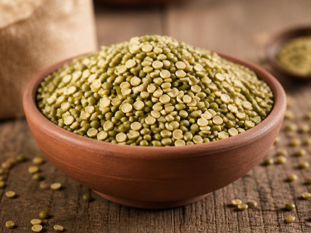 Split moong dal with green husk retained in a clay bowl